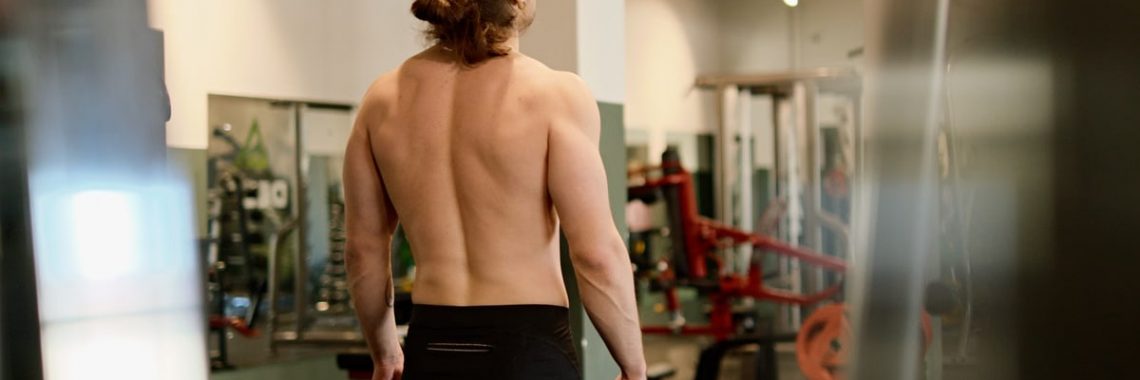 A fit man working out in a gym, highlighting exercise and fitness lifestyle.